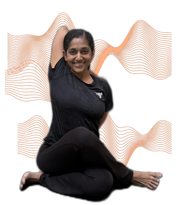 Rashmi Ramesh, founder of Yogalates Strength Plus, smiling during a yoga stretch